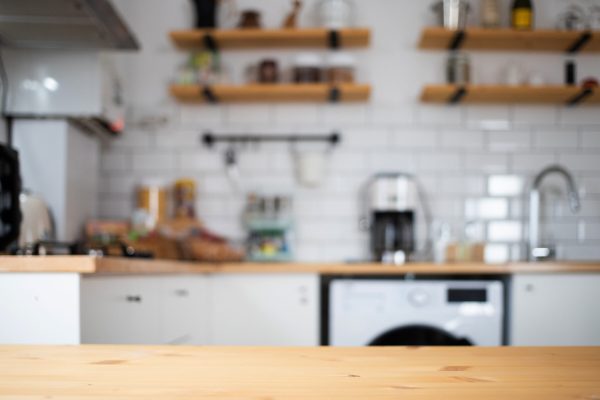 empty wooden tabletop and blurred kitchen mock up for product display